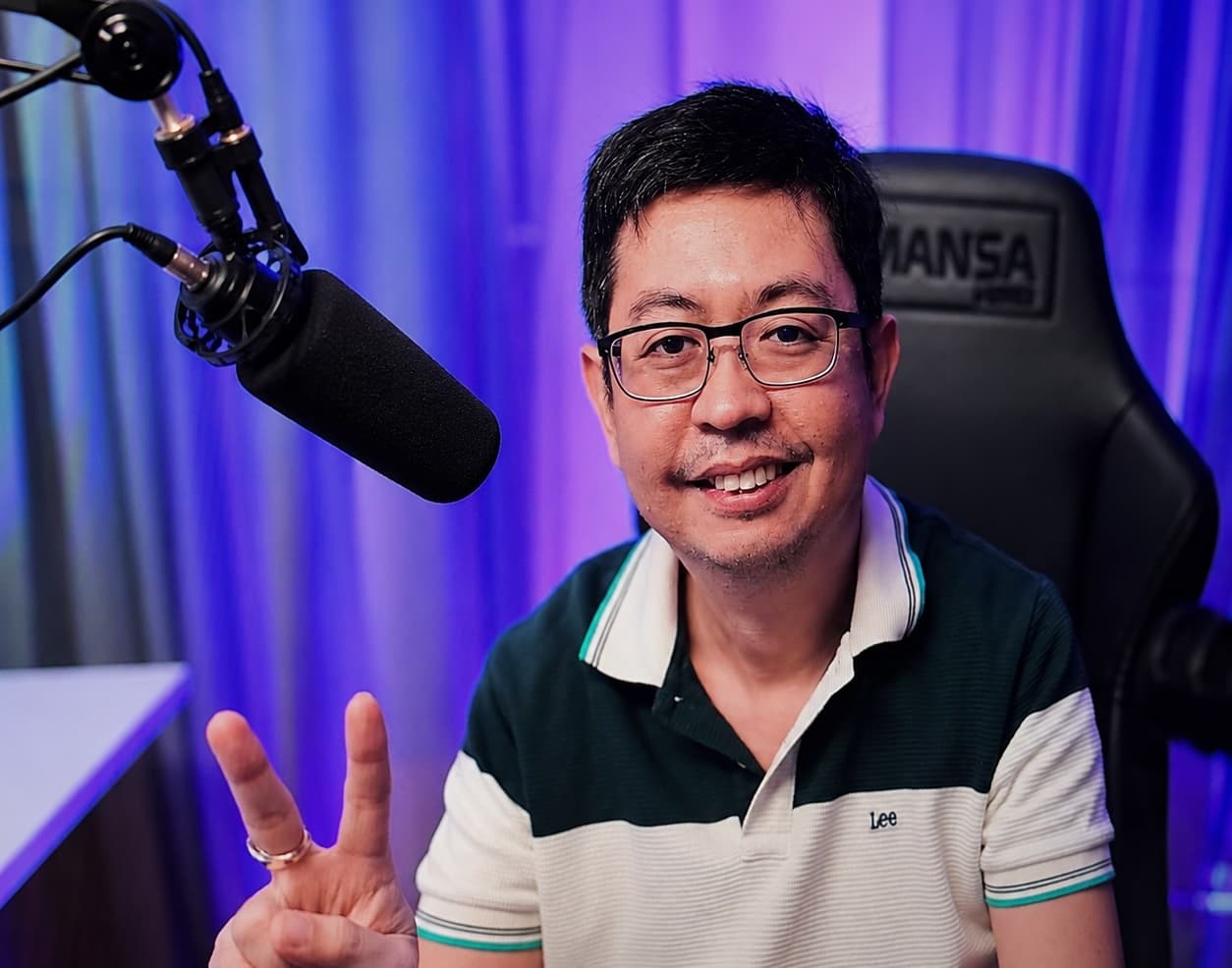 Melvin Vivas smiling at the boom mic in his studio